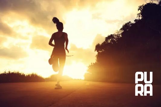 Mujer entrenando al aire libre al amanecer con actitud concentrada y equilibrada, representando disciplina inteligente y entrenamiento sostenible sin exceso.